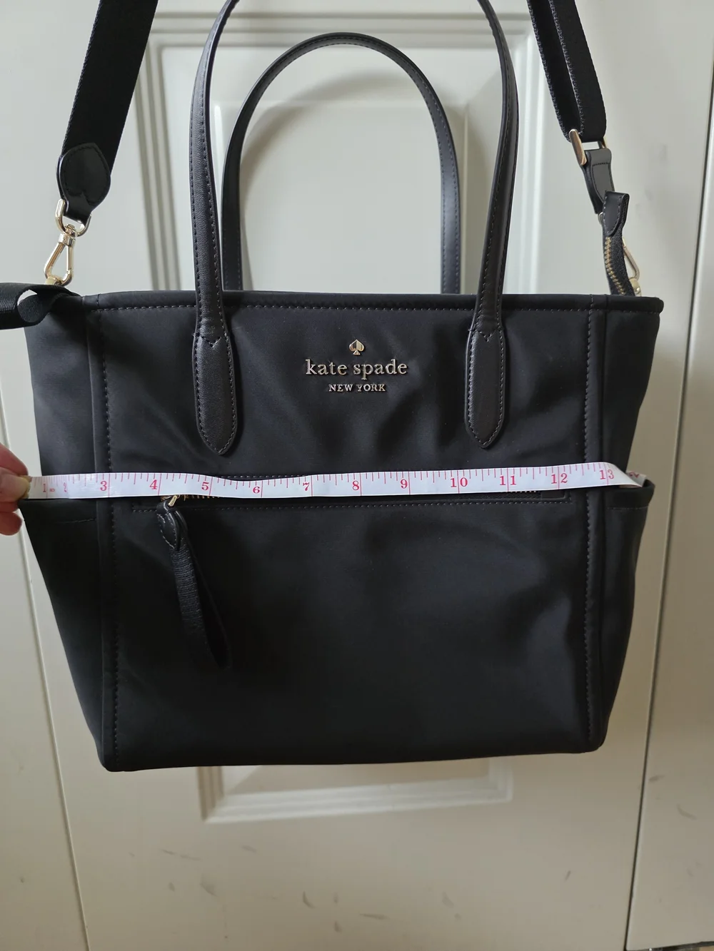 kate spade black tote with gold-tone logo and zipper
